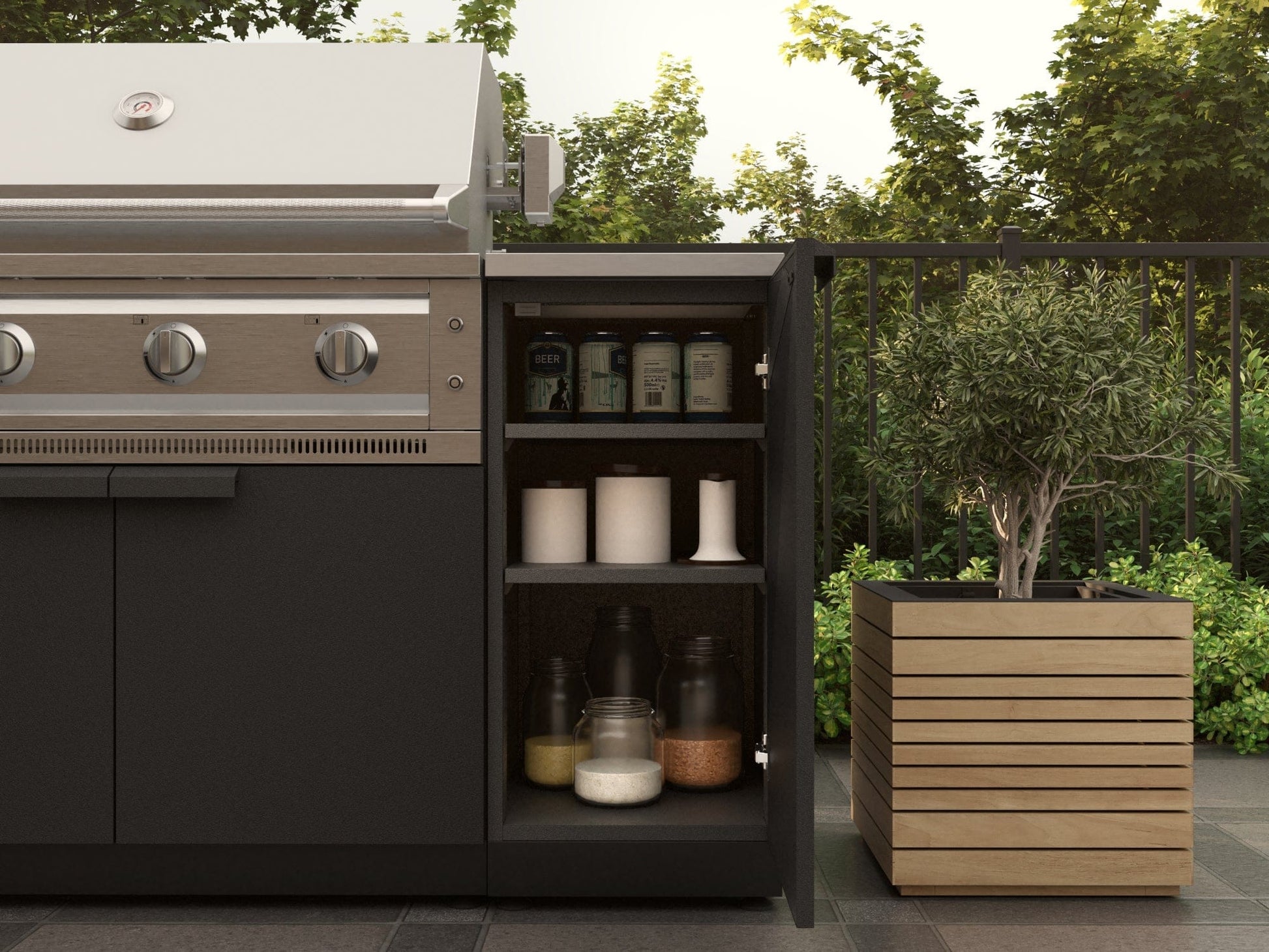 Premium modular outdoor kitchen grill with open cabinet, beside potted plant, on a tiled patio.