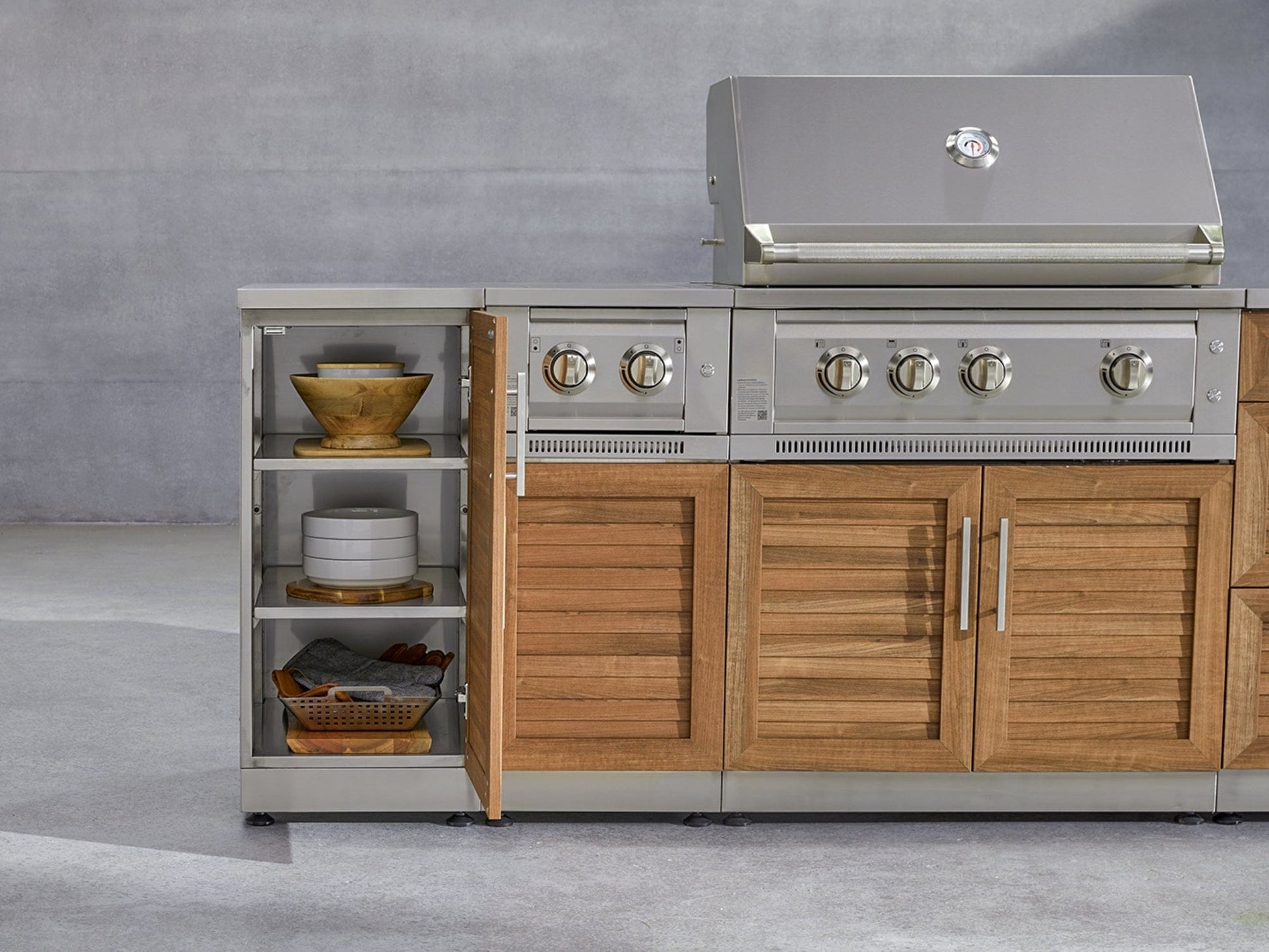 Outdoor kitchen cabinets and 304 stainless steel grill with open shelves for bowls and utensils, perfect for entertaining.