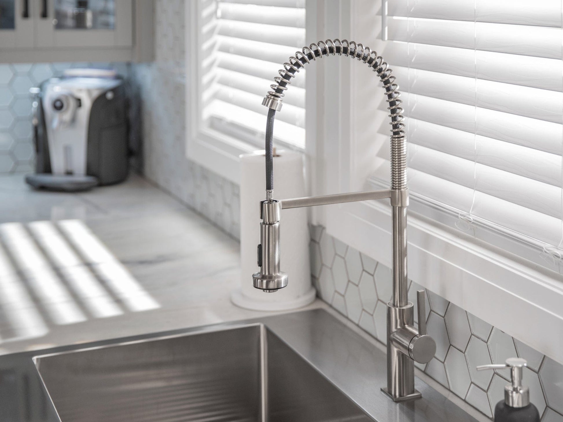 Premium NewAge outdoor sink with spring faucet, soap dispenser, hex tile backsplash, and stainless cabinets.