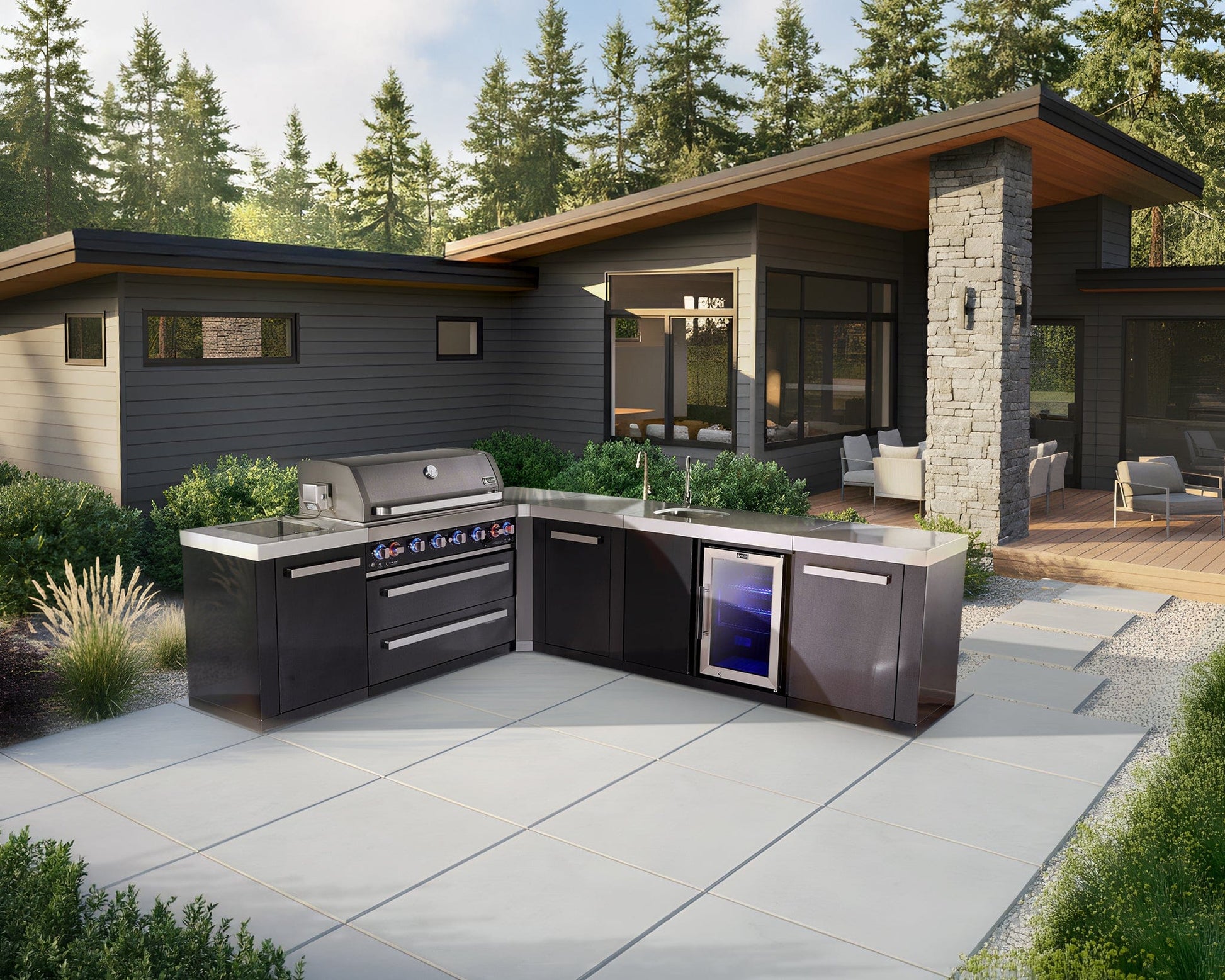 Mont Alpi outdoor kitchen with black stainless grill, built-in fridge, and modern patio setup by the house.