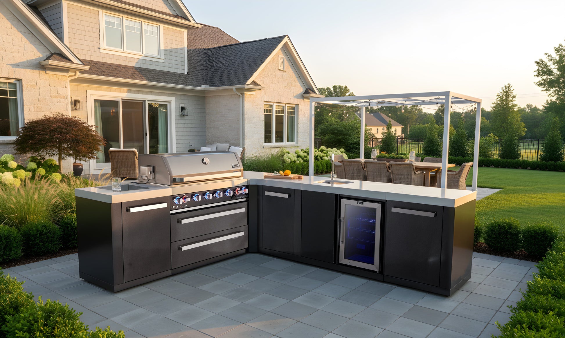 Premium outdoor kitchen with Mont Alpi grill, built-in sink, and fridge, perfect for patio dining areas.