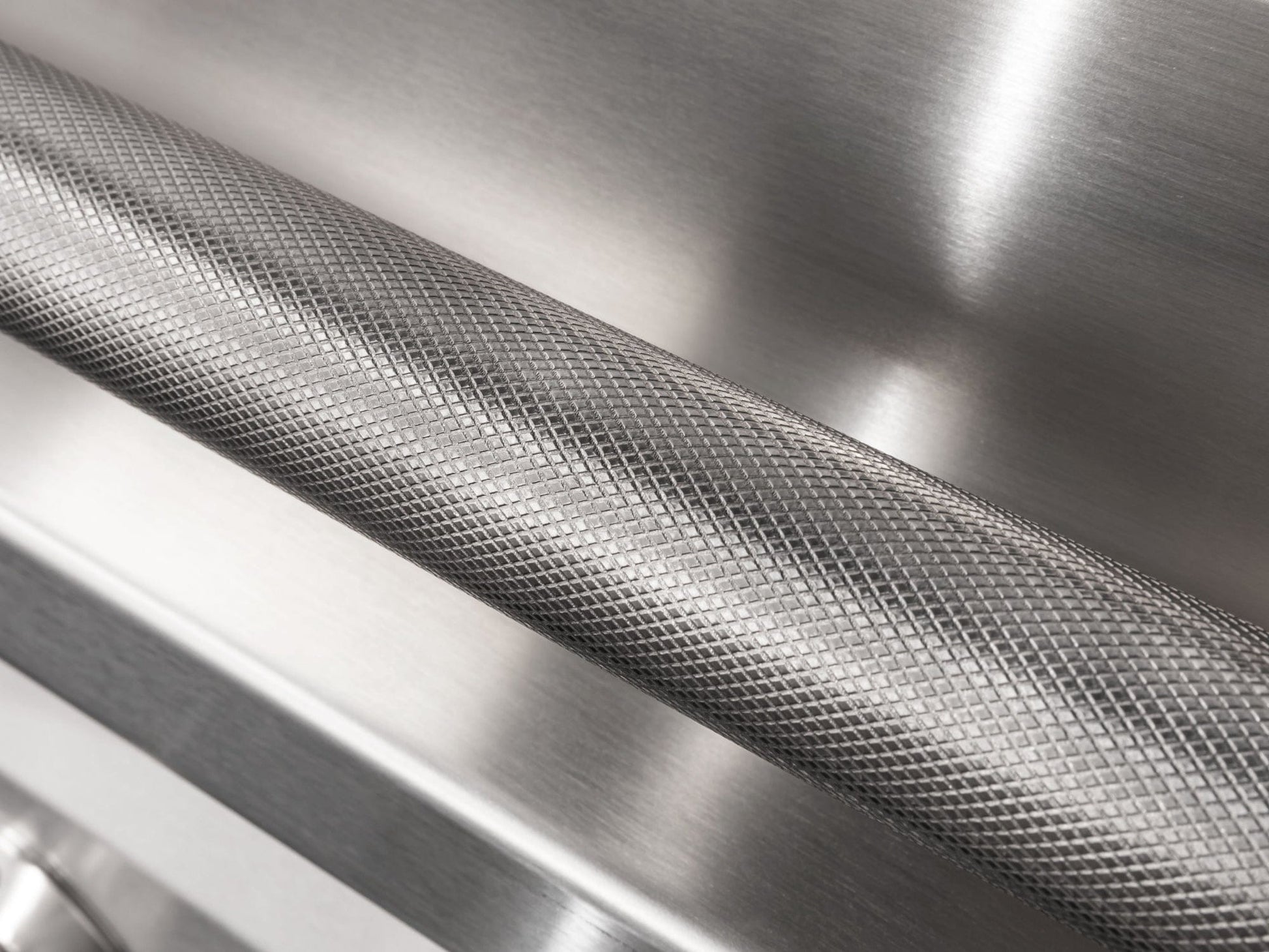 Textured barbell-style handle on a sleek steel panel, inspired by upscale modular outdoor kitchen design.