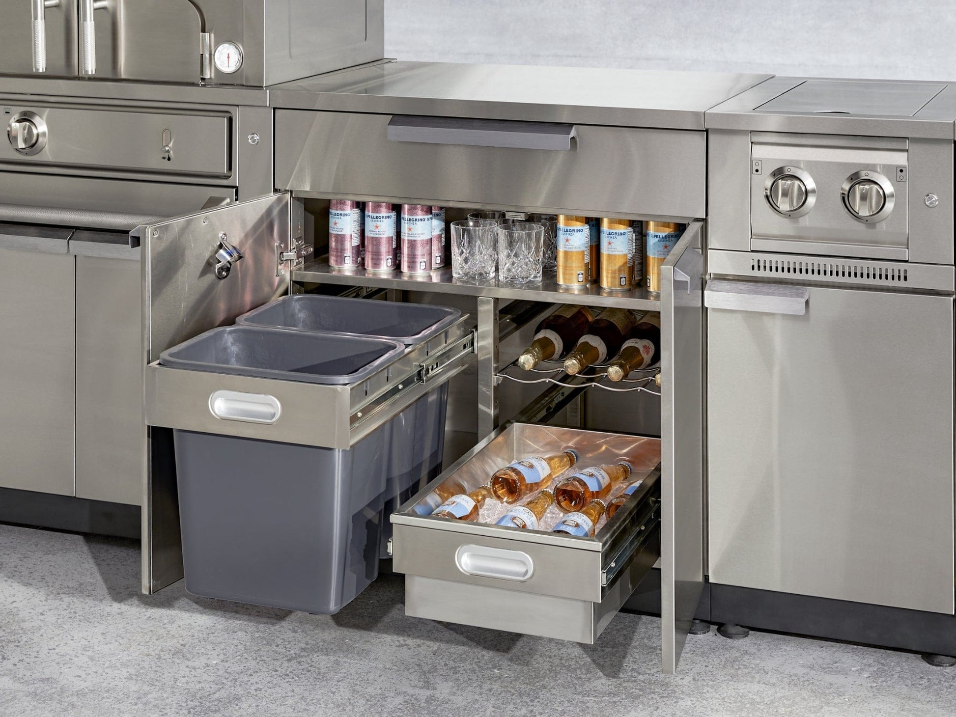 Stainless steel kitchen drawers with built-in trash bins and drink storage, perfect for luxury outdoor kitchens.
