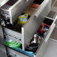 Three open stainless steel cabinets organize pet food, treats, bowls, and cleaning supplies in a sleek outdoor finish.