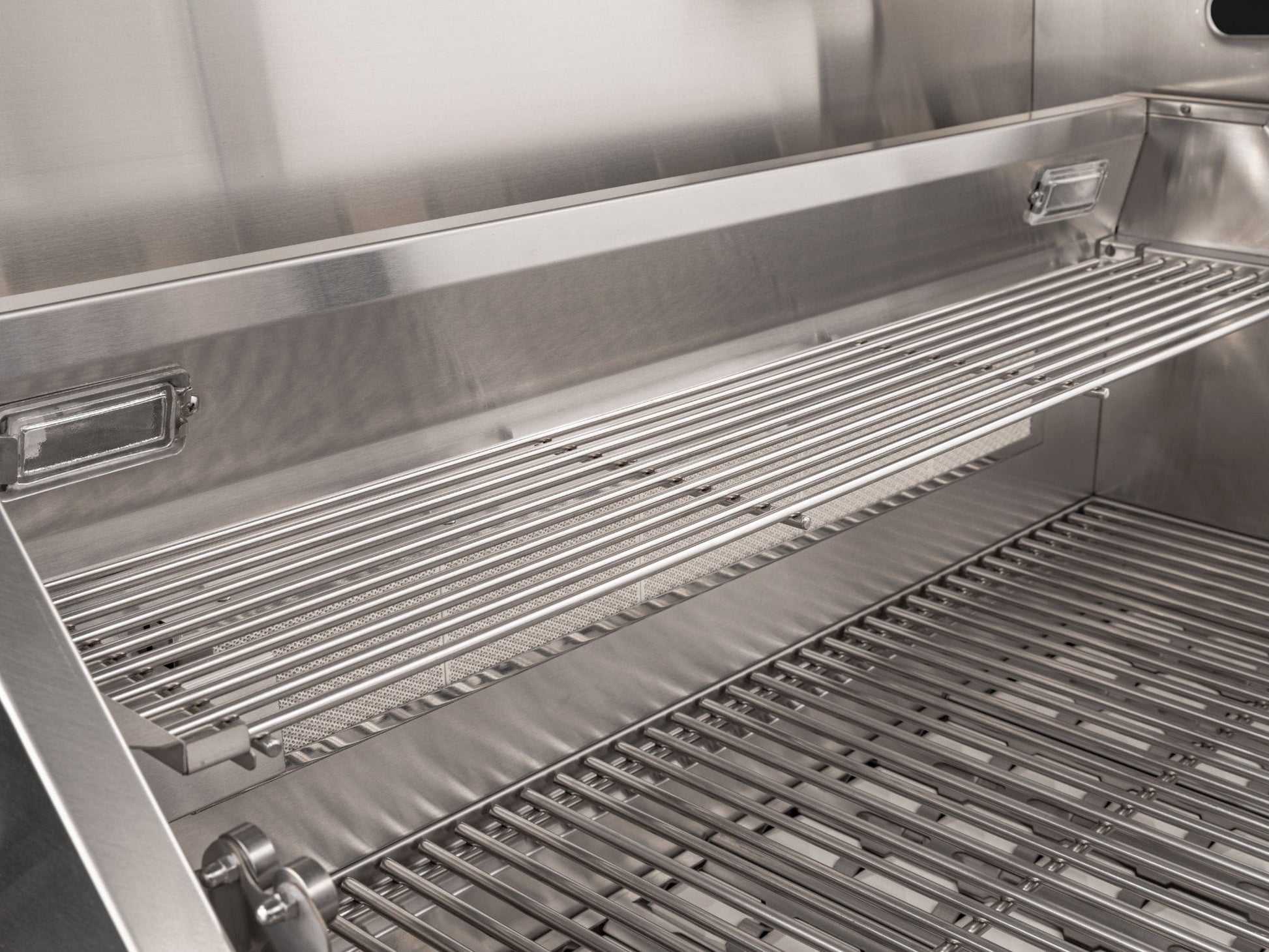 NewAge stainless steel grill with spotless grates, beside modular outdoor kitchen cabinets and sleek finish.