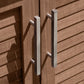Brown outdoor kitchen cabinet doors with slatted design and dual vertical metal handles for a premium finish.