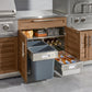 Open wooden outdoor kitchen cabinets with pull-out trash bins, stainless steel grills, and premium outdoor finish.