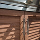 Premium NewAge outdoor kitchen cabinets with brushed metal handles beneath a stainless appliance with control knobs.