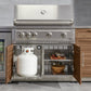 Outdoor stainless steel grill with open doors showing storage, propane tank, and kitchen accessories.