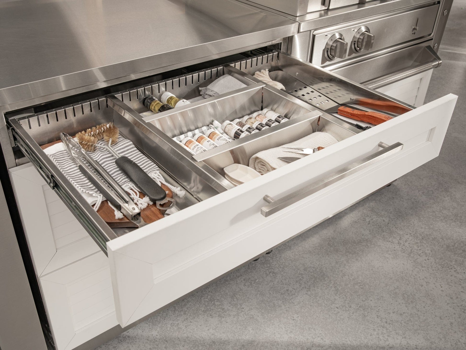 Modular drawer organizes utensils and spices; premium outdoor kitchen storage with sleek, weather-resistant finish.