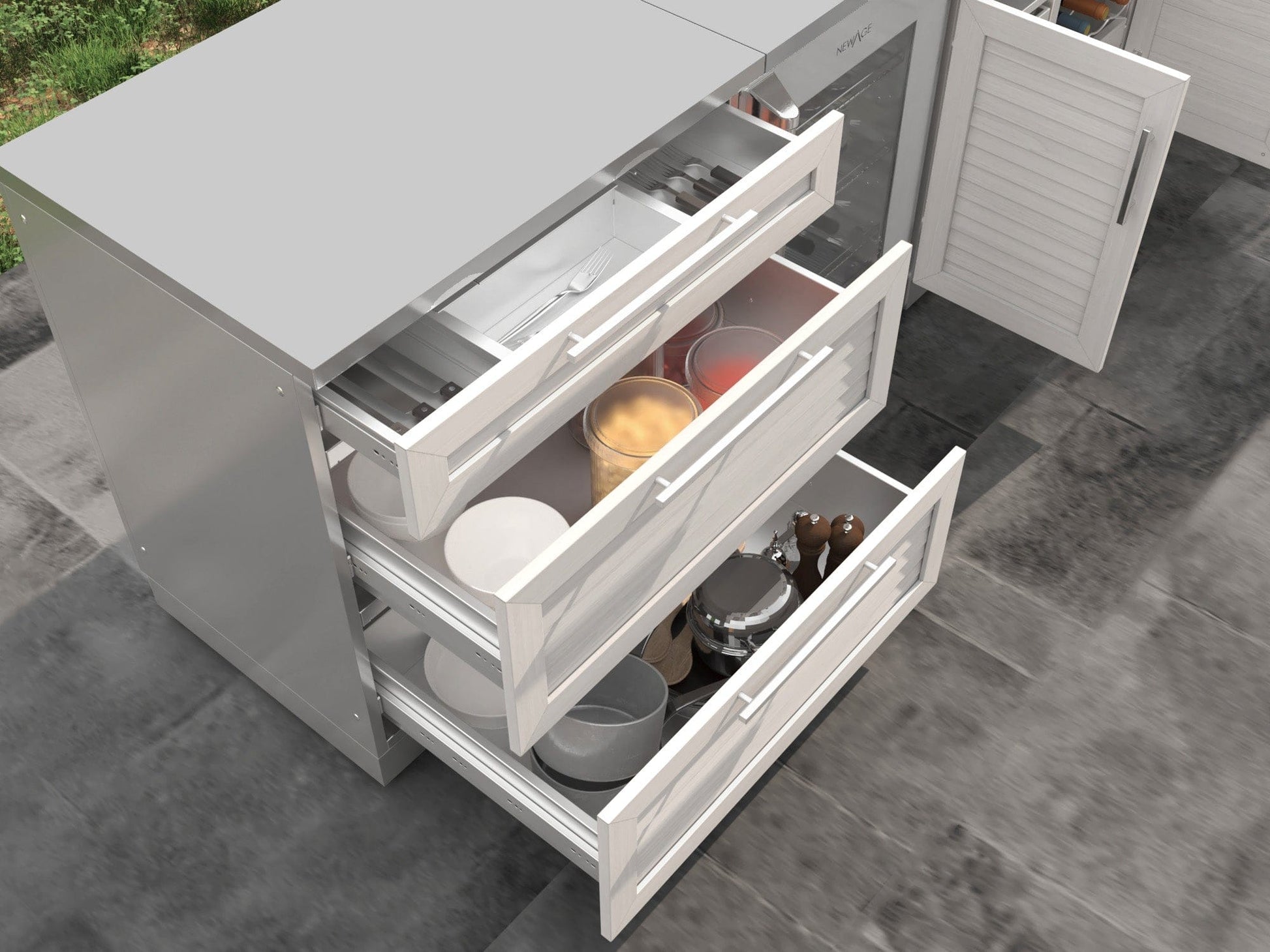Sleek outdoor kitchen cabinets with three open drawers showing utensils, pots, and dishes; durable stainless steel finish.