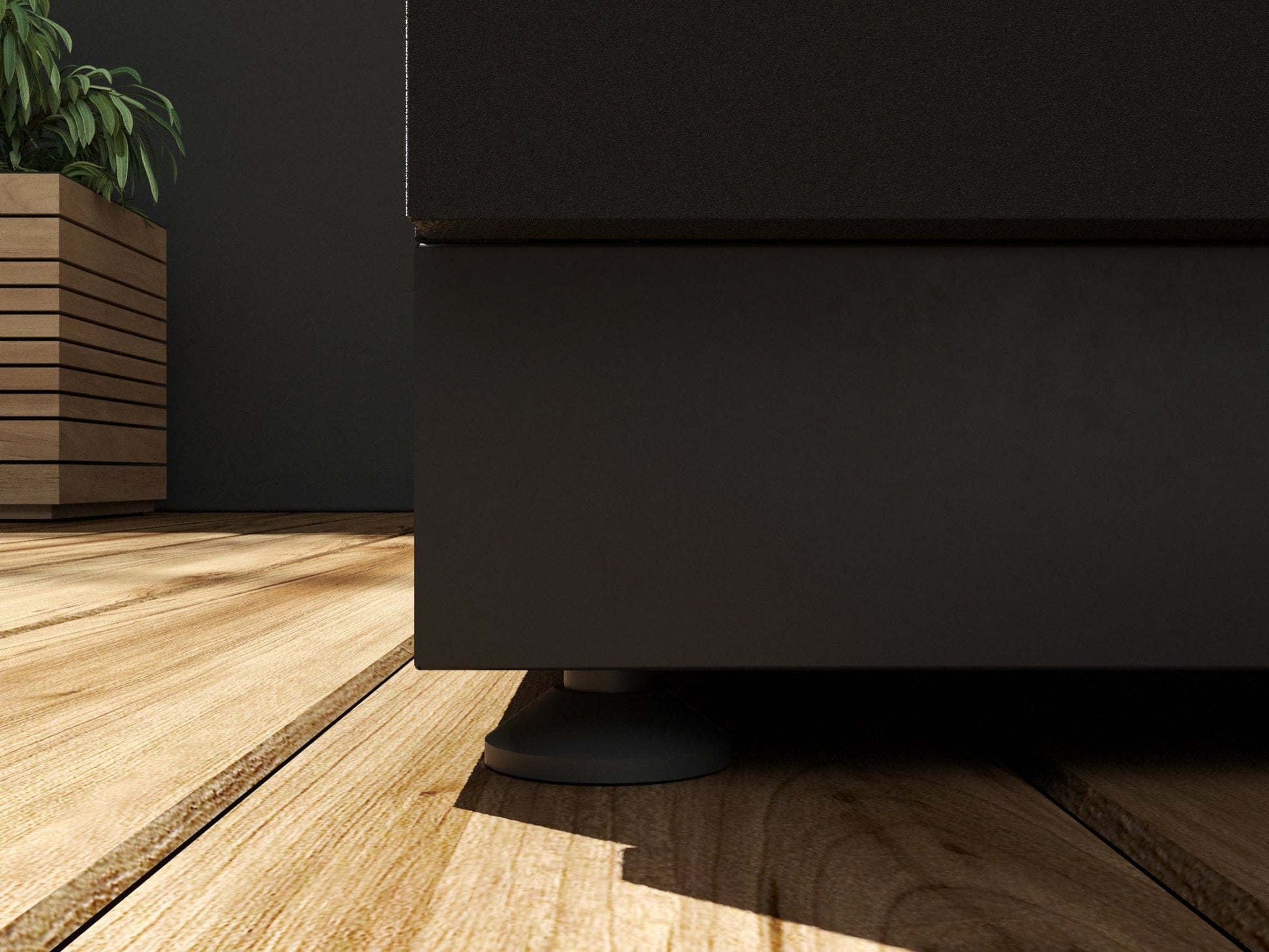Premium black stainless steel outdoor cabinets on wood floor, sleek finish, with plant accent in background.